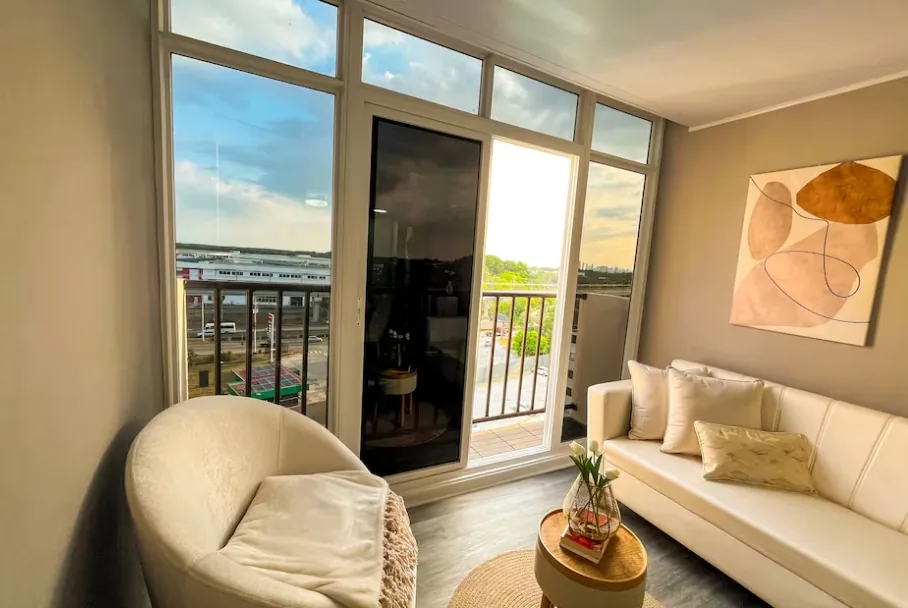 Bright living room with balcony door and sofa, Tocumen airbnb Panama